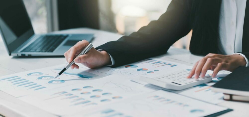 Close-up of financial charts and graphs being analyzed, showcasing financial reporting services in UAE
