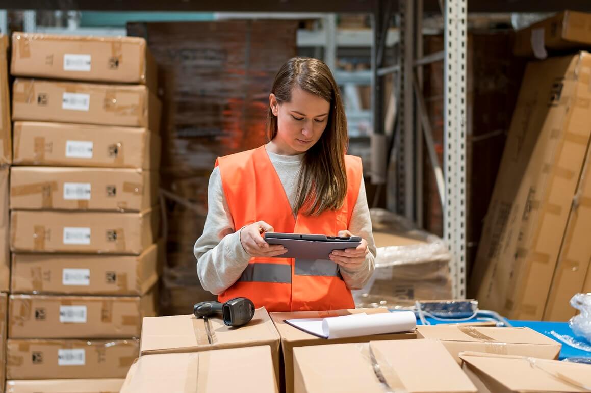 Image of a woman using a tablet in a modern office, representing the role of technology in asset management.